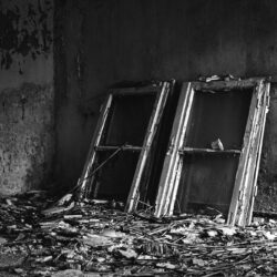 grayscale-shot-window-frames-placed-messy-floor-old-house